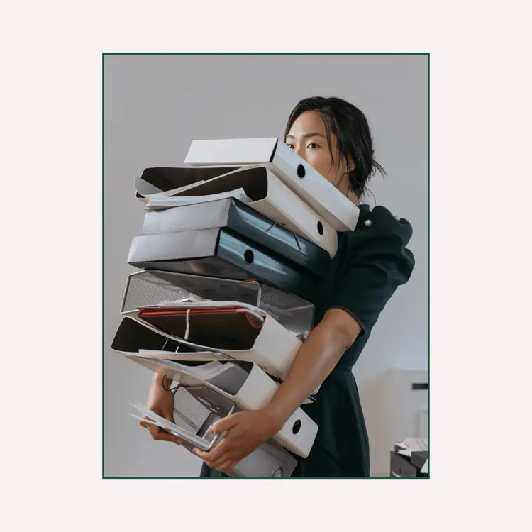 A Woman Holding a Pile of File Folders