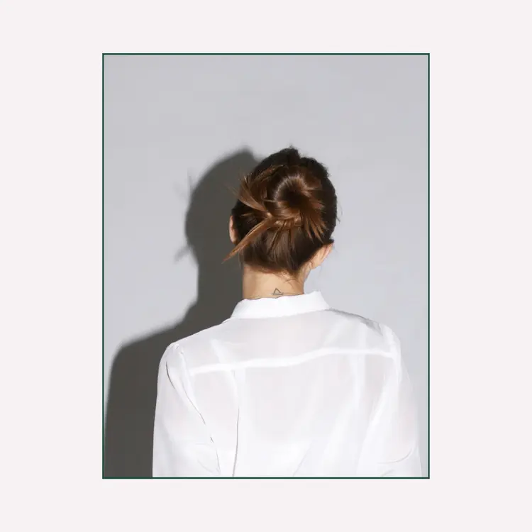 Back View of a Woman with a Hair Bun. Signs of blocked feminine energy