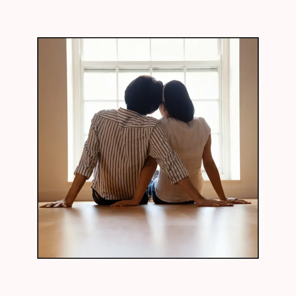 Loving Couple looking out a window. Signs Of A Mature & Healthy Relationship