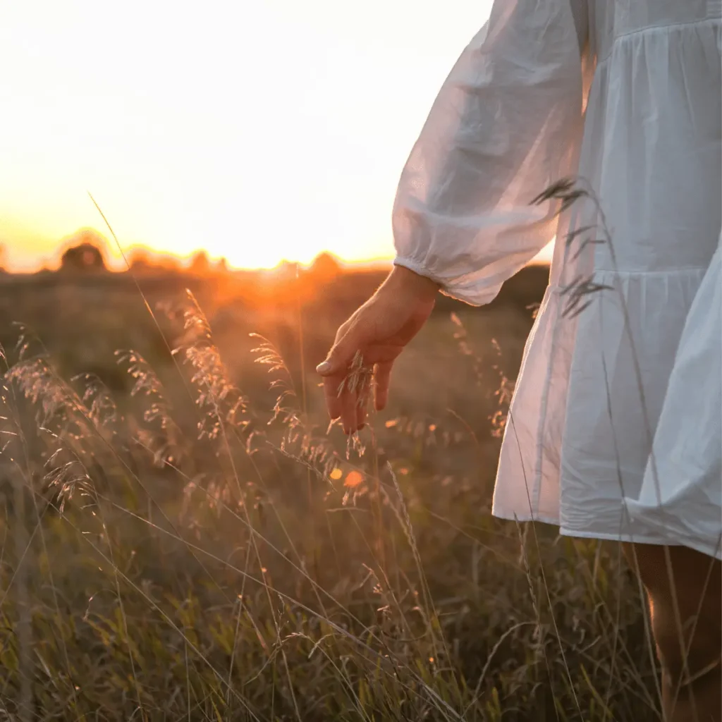 Woman field in nature. Happy people lifestyle. Scripting Manifestation Technique