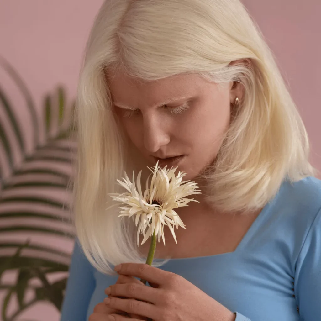 medium shot of a woman holding a white flower Sunday self-care quotes