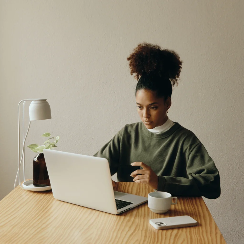 woman working at a laptop. powerful manifestation methods