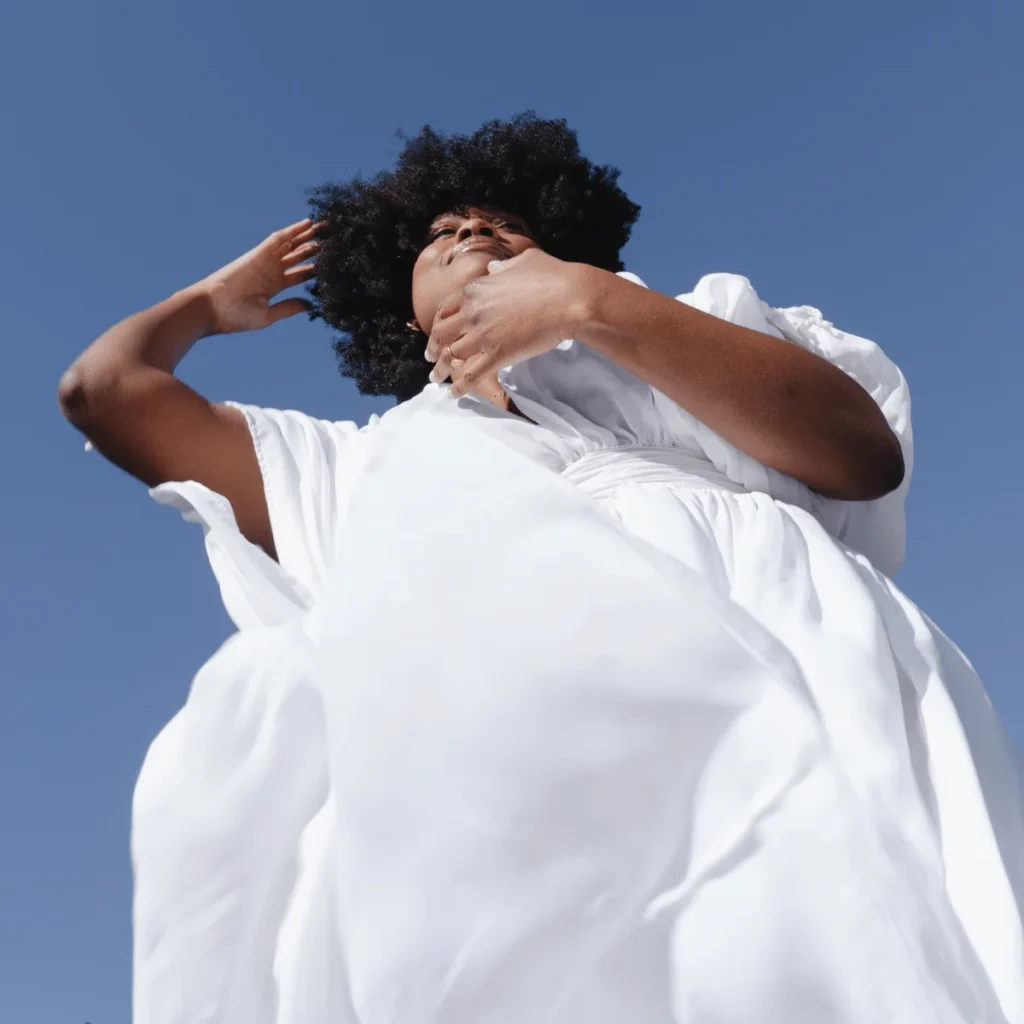 Woman in a White Flowy Dress on a Clear Day