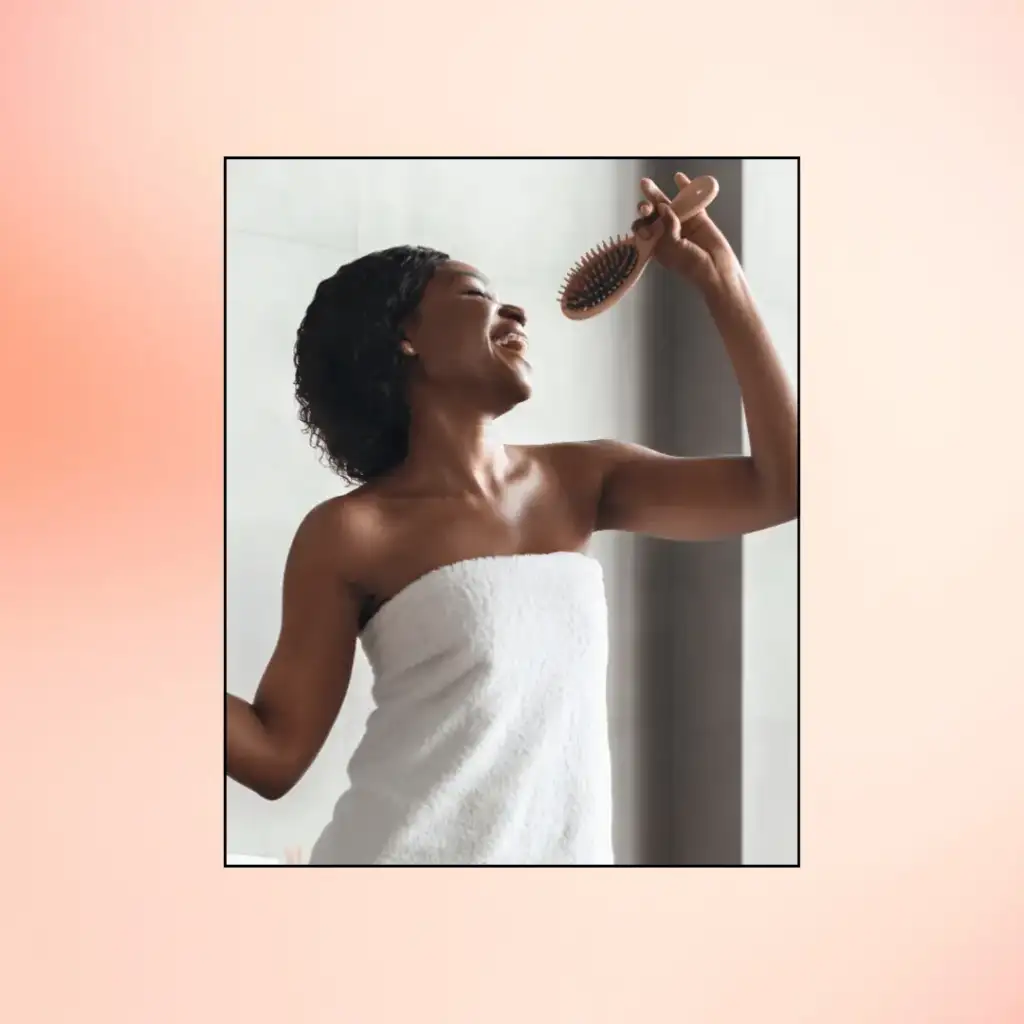 Black Young Woman Enjoying Haircare Singing with Hairbrush