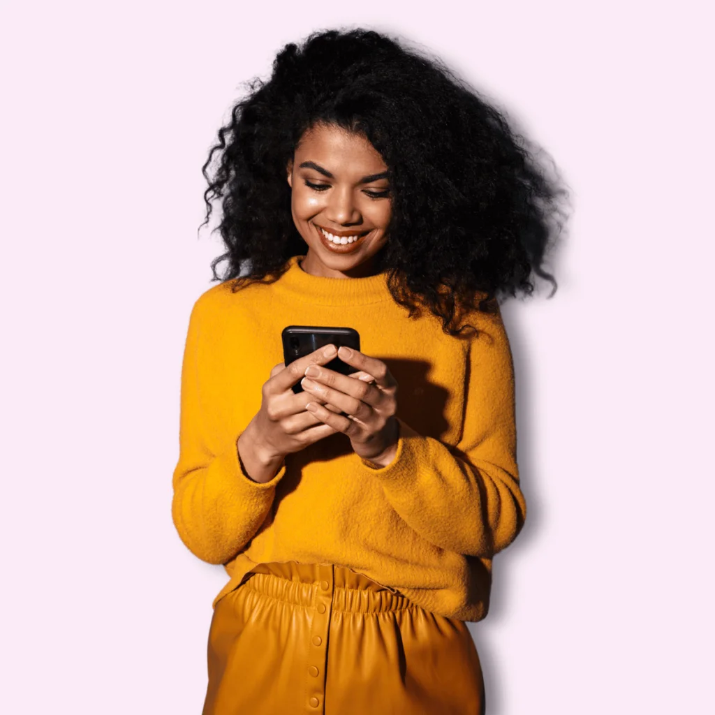 Smiling-Happy-Beautiful-Black-Woman-Using-Mobile-Phone.