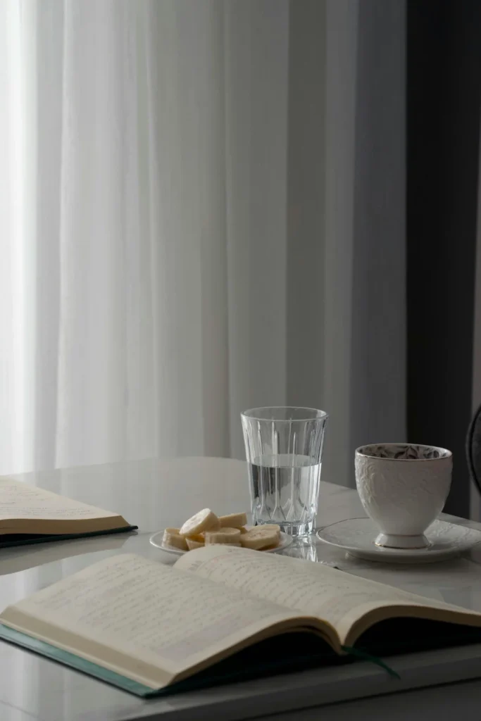 Table display of a notebook, sliced bananas and a tea cup. Journaling Prompts for Couples