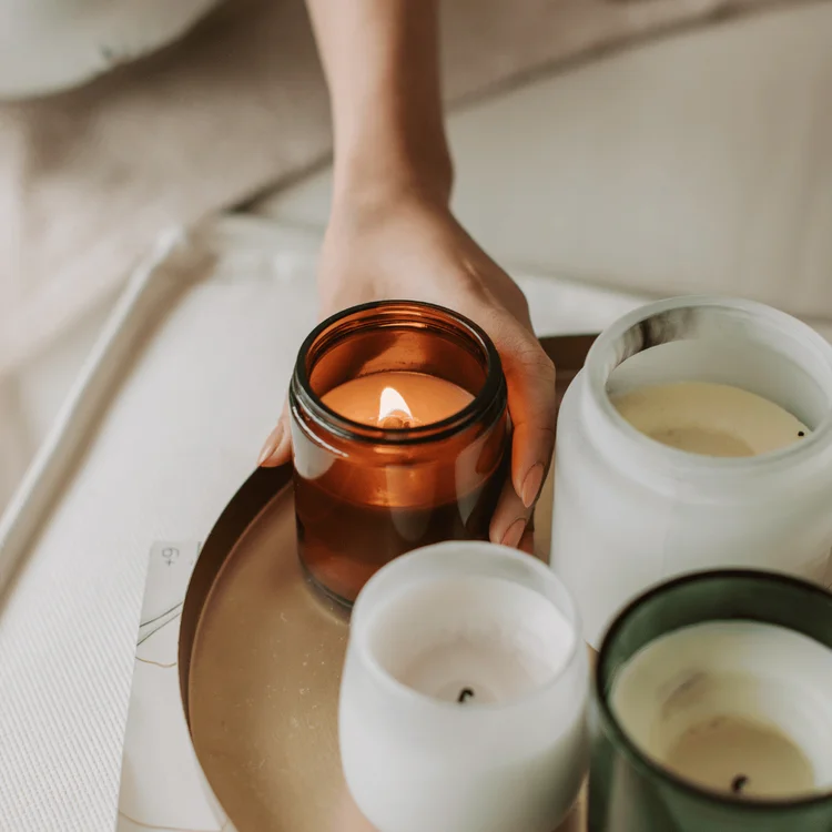 Woman Lighting a Candle in Jar