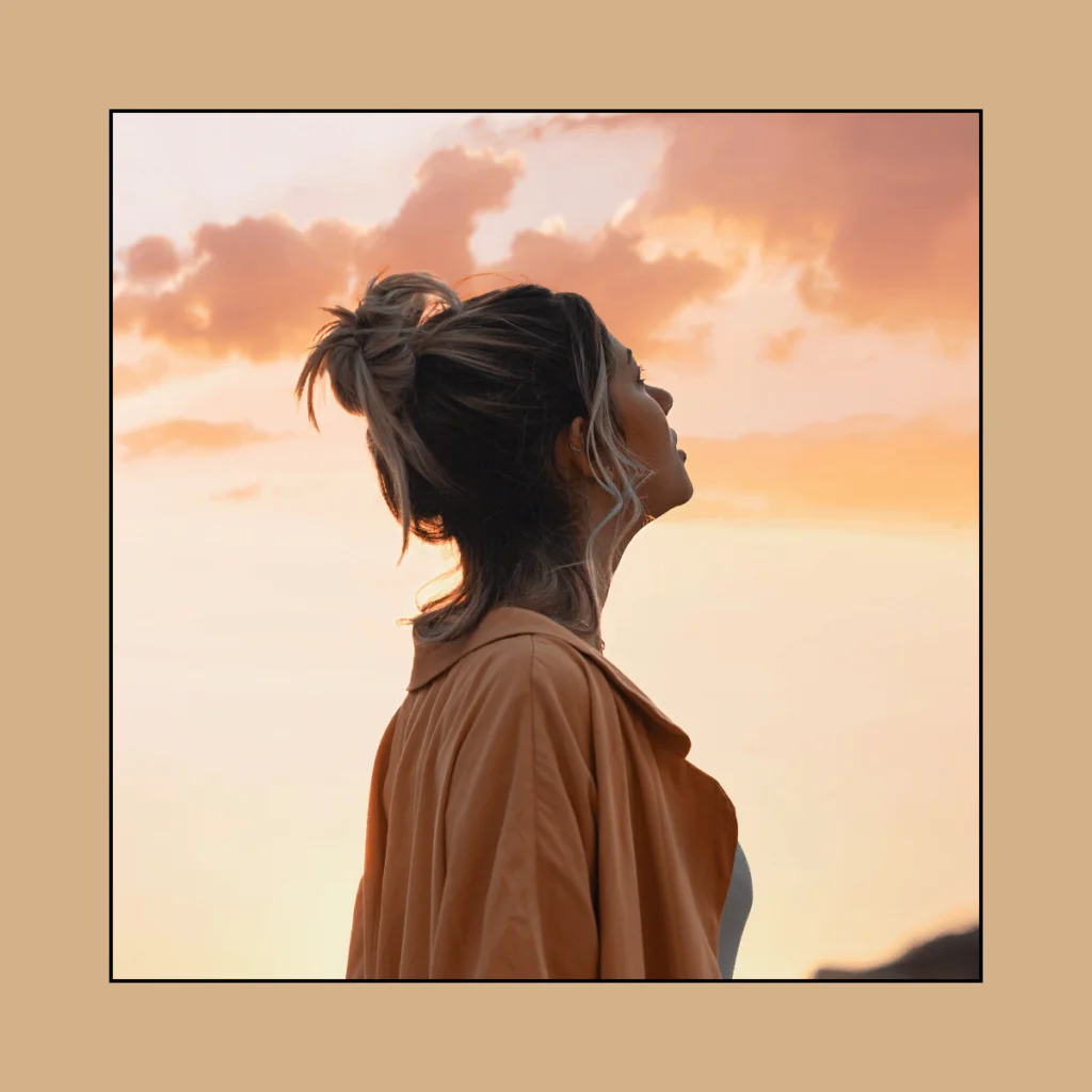 Woman-gazing-at-the-sky-during-sunrise.-100-Solo-Date-Ideas