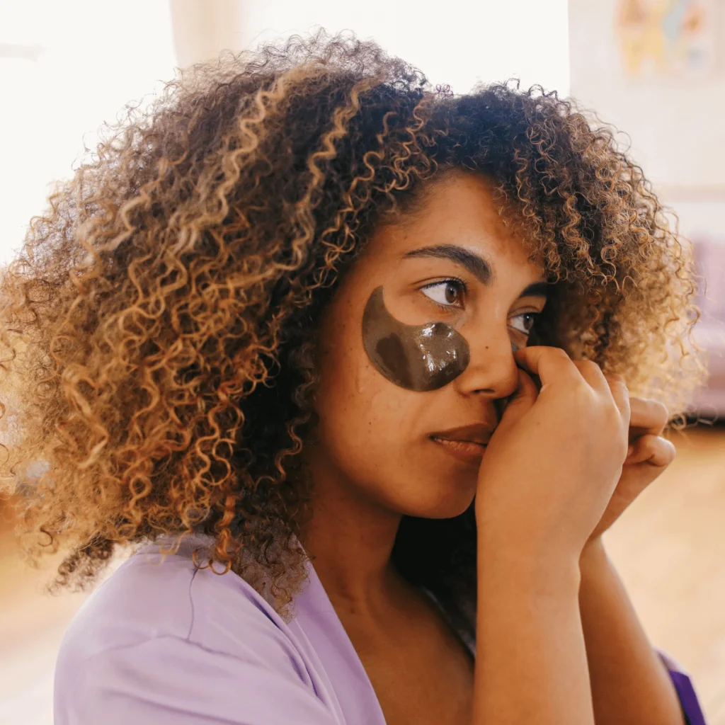 Woman-in-loungewear-applying-eye-patches.-100-Solo-Date-Ideas