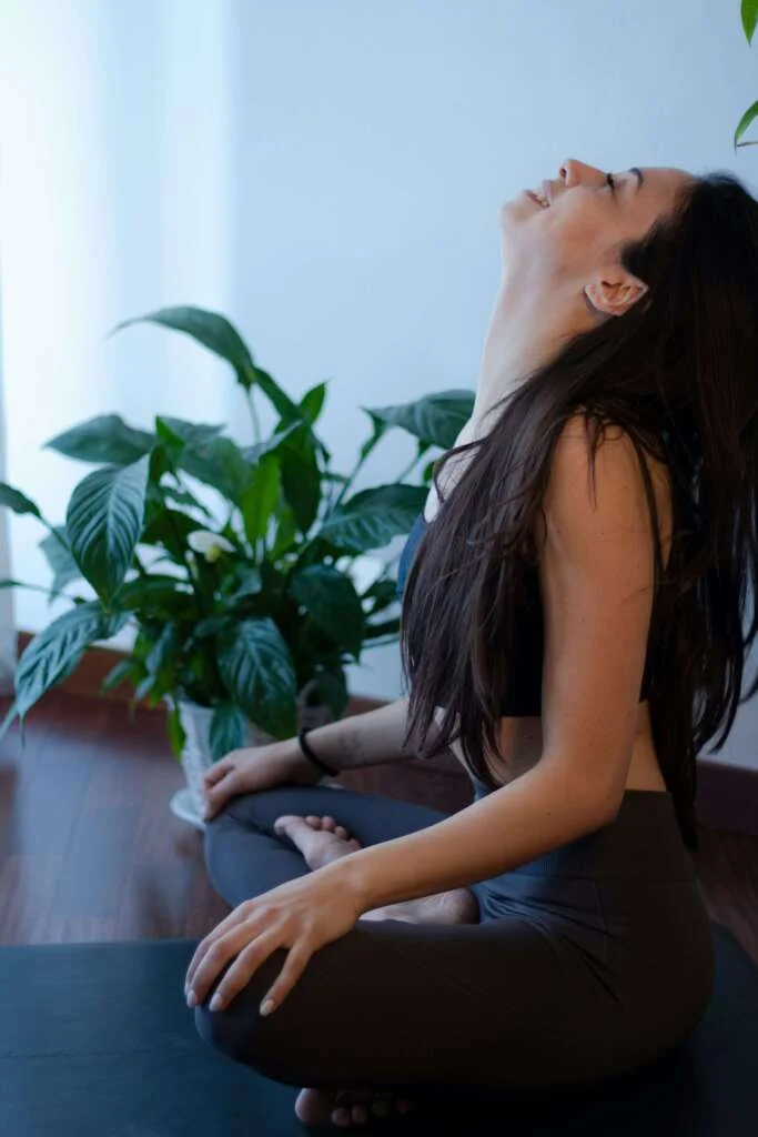 Woman smiling doing yoga at home. Saturday self care routine