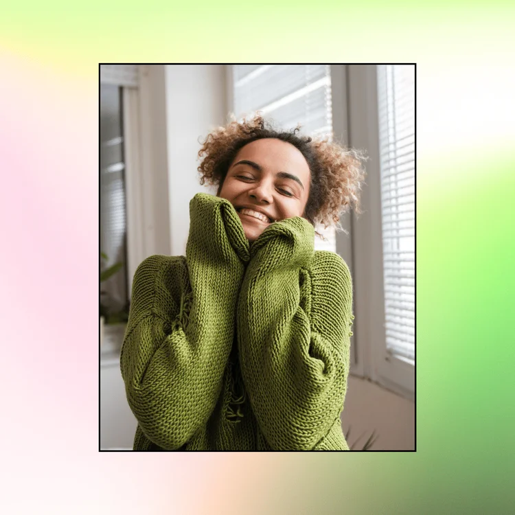 Woman wearing a green jumper hugging herself. Powerful Gratitude Affirmations