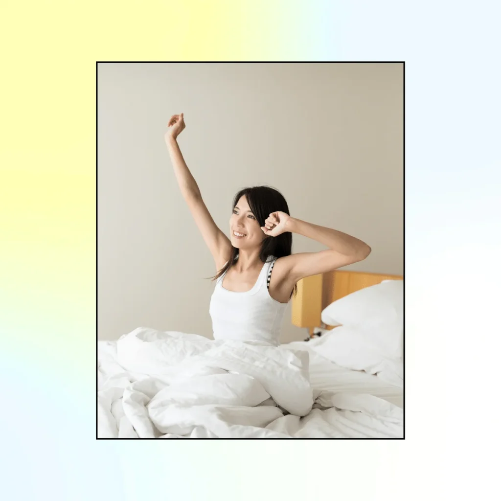 Woman yawns and stretching in her bed in the morning.