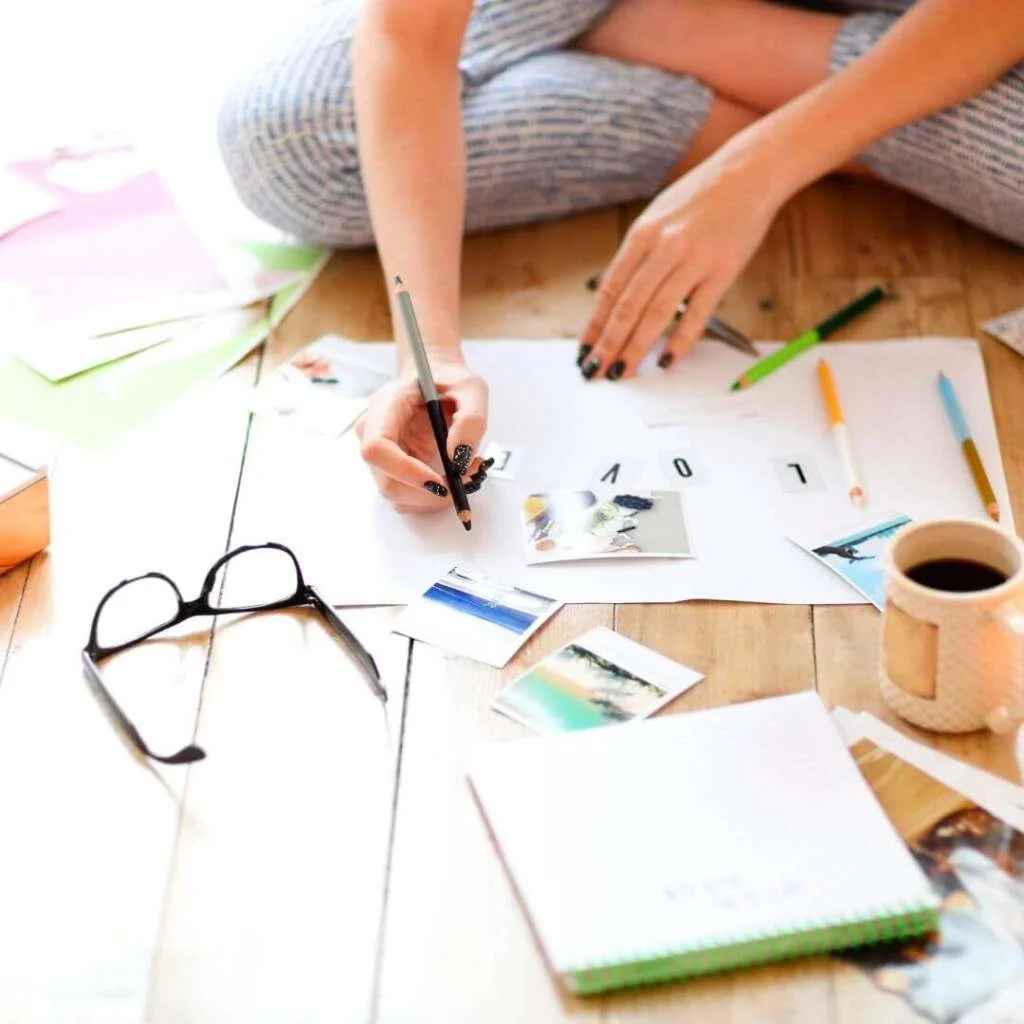 Young Brunette Woman Creating Her Feng Shui Wish Map Using Sciss. Feminine Vision Board