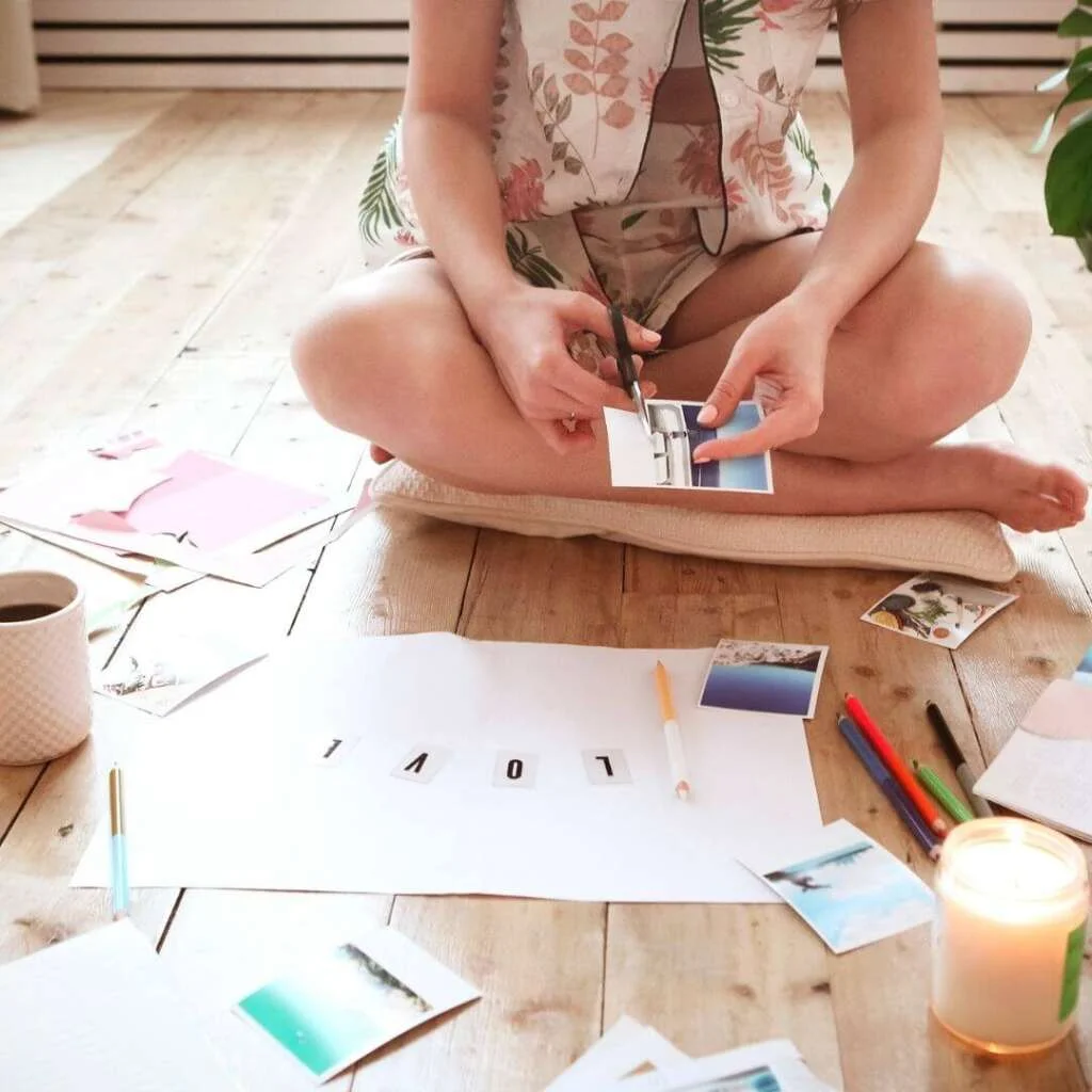 Young Brunette Woman Creating Her Feng shui Wish Map Using Sciss. Feminine Vision Board