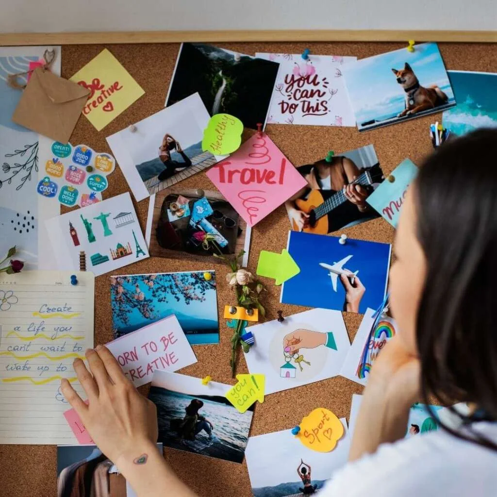 woman creating their own vision board. Feminine vision board