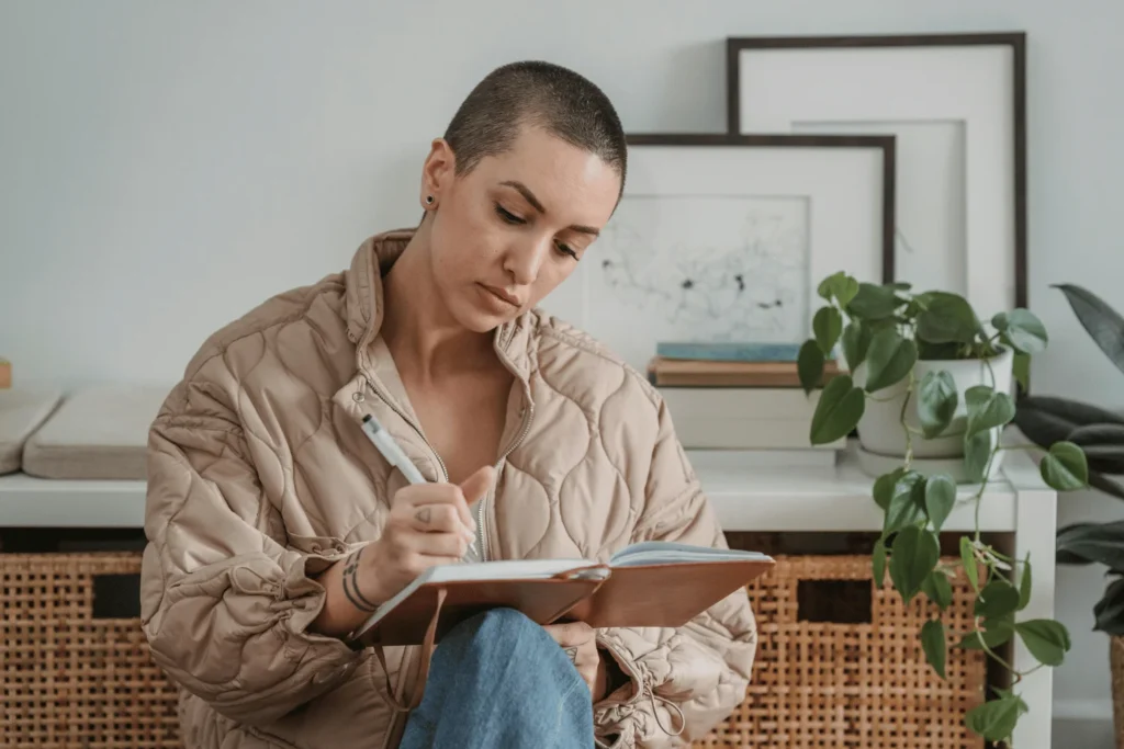 Concentrated woman taking notes in diary