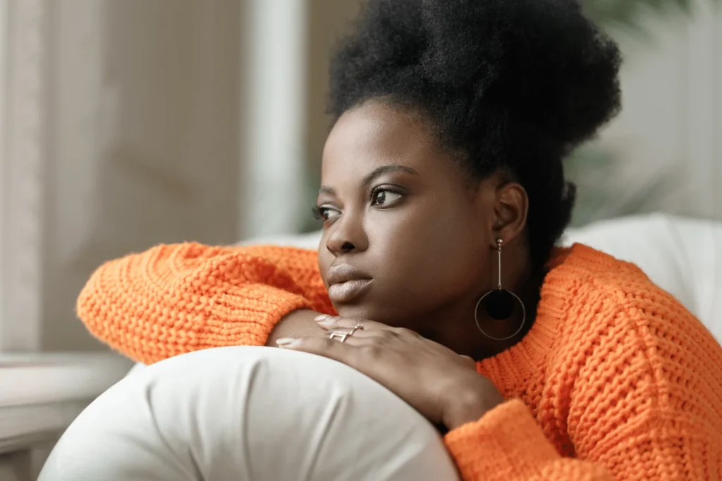 Pensive Woman Resting on a Couch