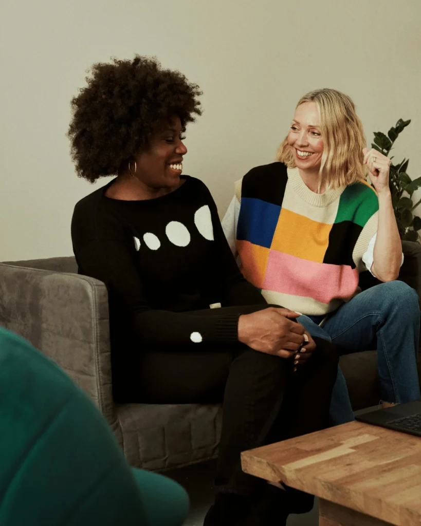 two friends talking on a sofa