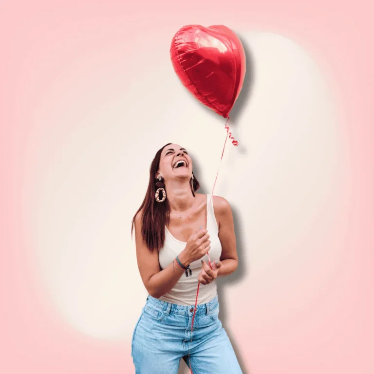 Woman-Smiling-While-Holding-a-Heart-Balloon-Outdoors.-How-to-be-happily-single-on-Valentines-day